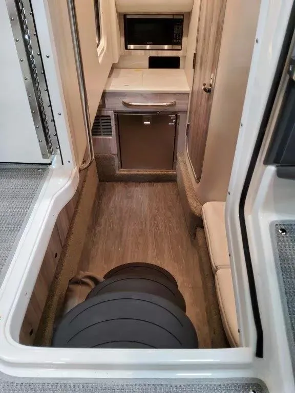 Slide: The Image of 2021 Formula 350 Crossover Bowrider I/O interior with kitchenette and seating area. - 23