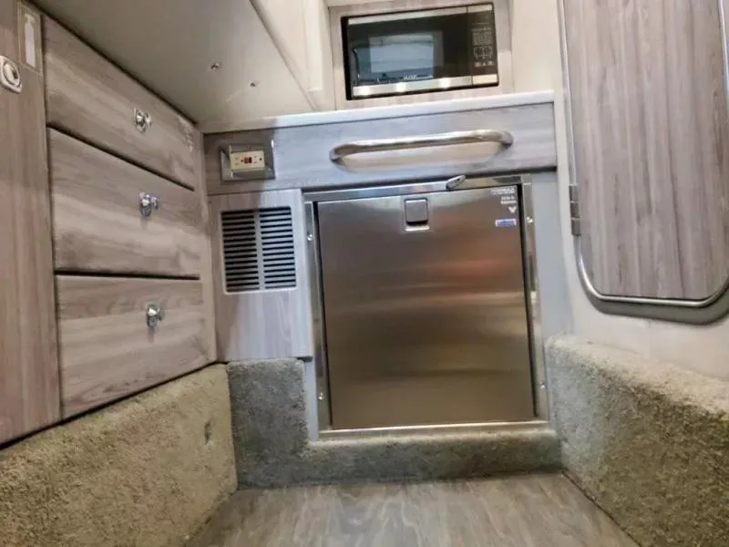 Slide: The Image of 2021 Formula 350 Crossover Bowrider I/O interior with microwave and storage cabinets. - 24