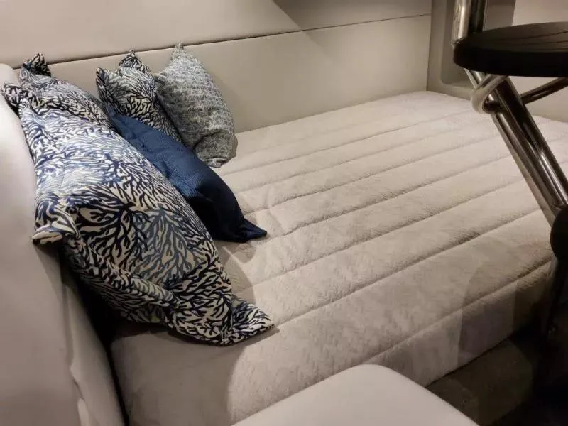 Slide: The Image of 2021 Formula 350 Crossover Bowrider I/O cabin with cozy bedding and decorative pillows. - 25
