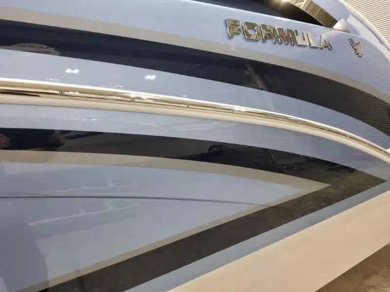 Slide: The Image of 2021 Formula 350 Crossover Bowrider I/O boat with sleek design and metallic accents. - 5