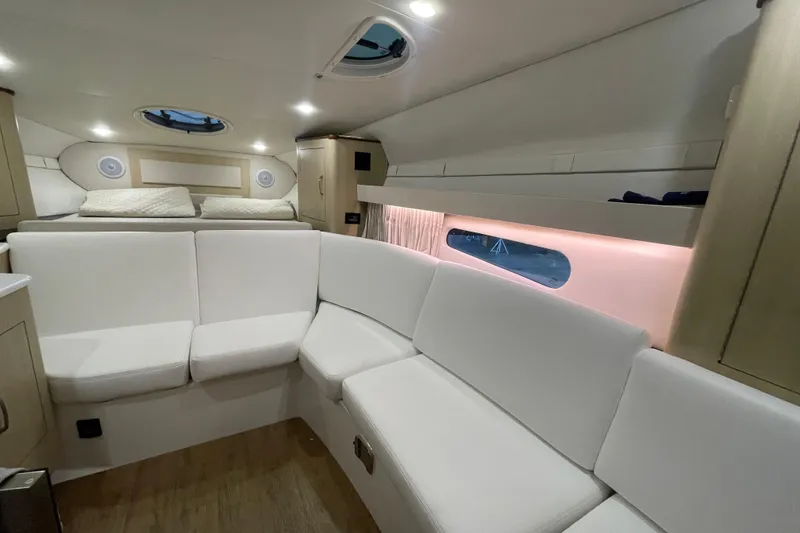 Slide: The Image of Luxurious interior of 2023 Regal 33 Express yacht with white seating and ambient lighting. - 23