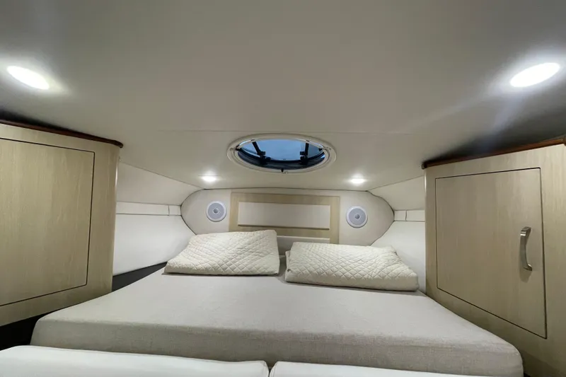 Slide: The Image of Interior cabin of 2023 Regal 33 Express yacht with cozy bedding and modern lighting. - 27