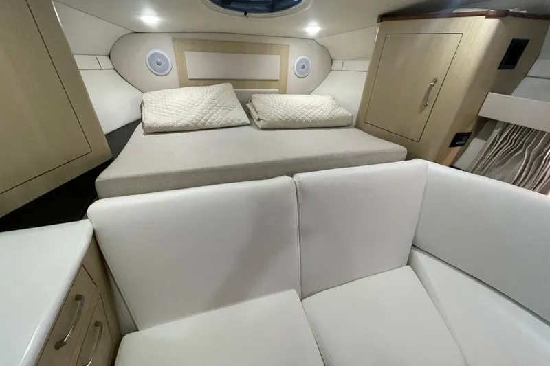 Slide: The Image of 2023 Regal 33 Express cabin interior with bed, seating, and storage. - 28