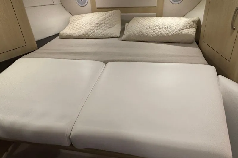 Slide: The Image of 2023 Regal 33 Express cabin interior with comfortable bedding and modern design. - 29