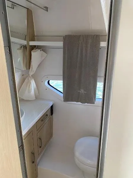 Slide: The Image of 2023 Regal 33 Express bathroom with modern fixtures and window. - 33