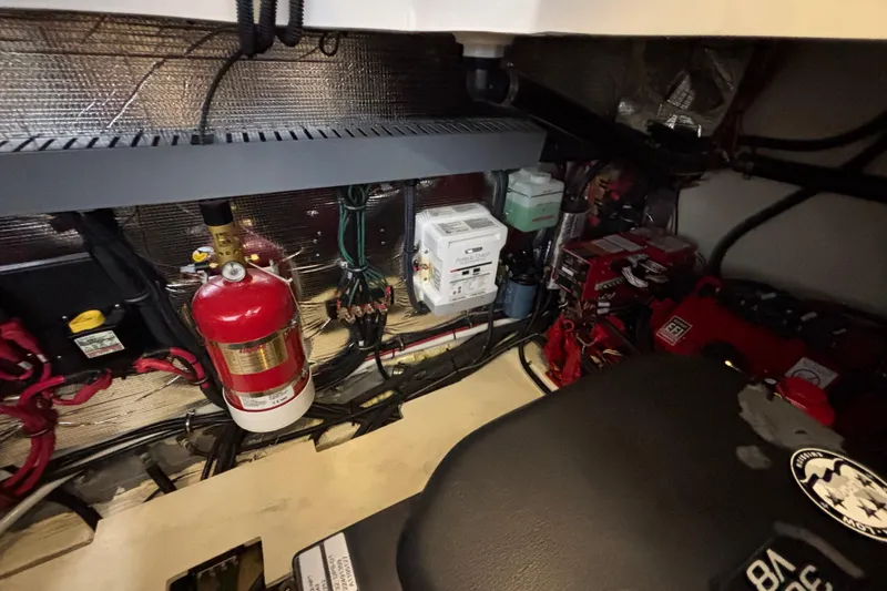 Slide: The Image of Engine room of 2023 Regal 33 Express with fire extinguisher and electrical components. - 36