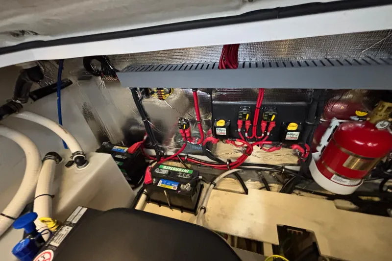 Slide: The Image of Engine compartment of 2023 Regal 33 Express boat with wiring and fire extinguisher. - 37