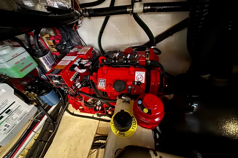 Slide: The Image of Engine compartment of 2023 Regal 33 Express boat, featuring a red EFI engine. - 41