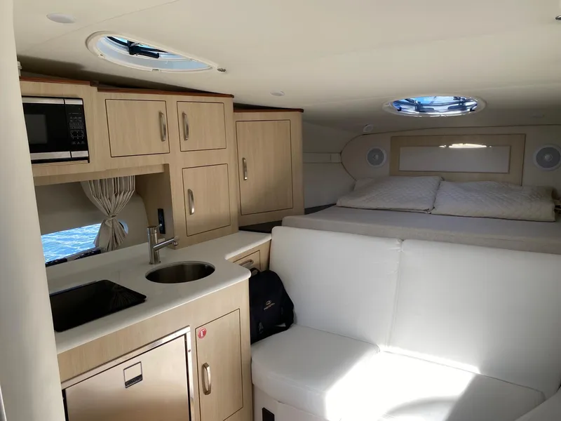 Slide: The Image of 2023 Regal 33 Express boat interior with sink, storage, and countertop accessories. - 9
