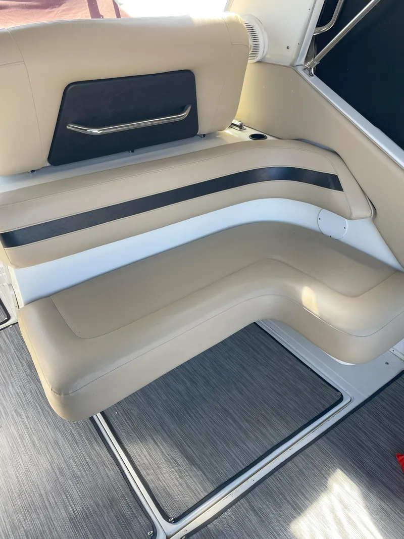 Slide: The Image of 1990 Sea Ray 390 Express Cruiser interior seating with beige and black accents. - 12
