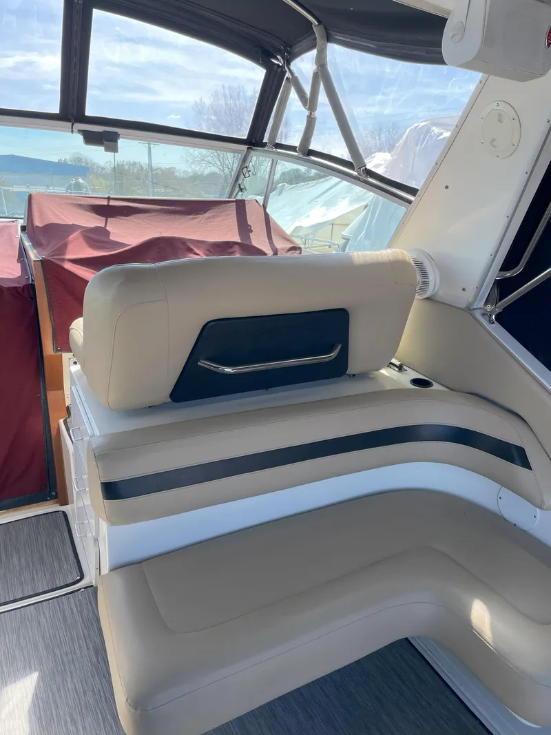 Slide: The Image of 1990 Sea Ray 390 Express Cruiser interior with beige seating and black accents. - 13