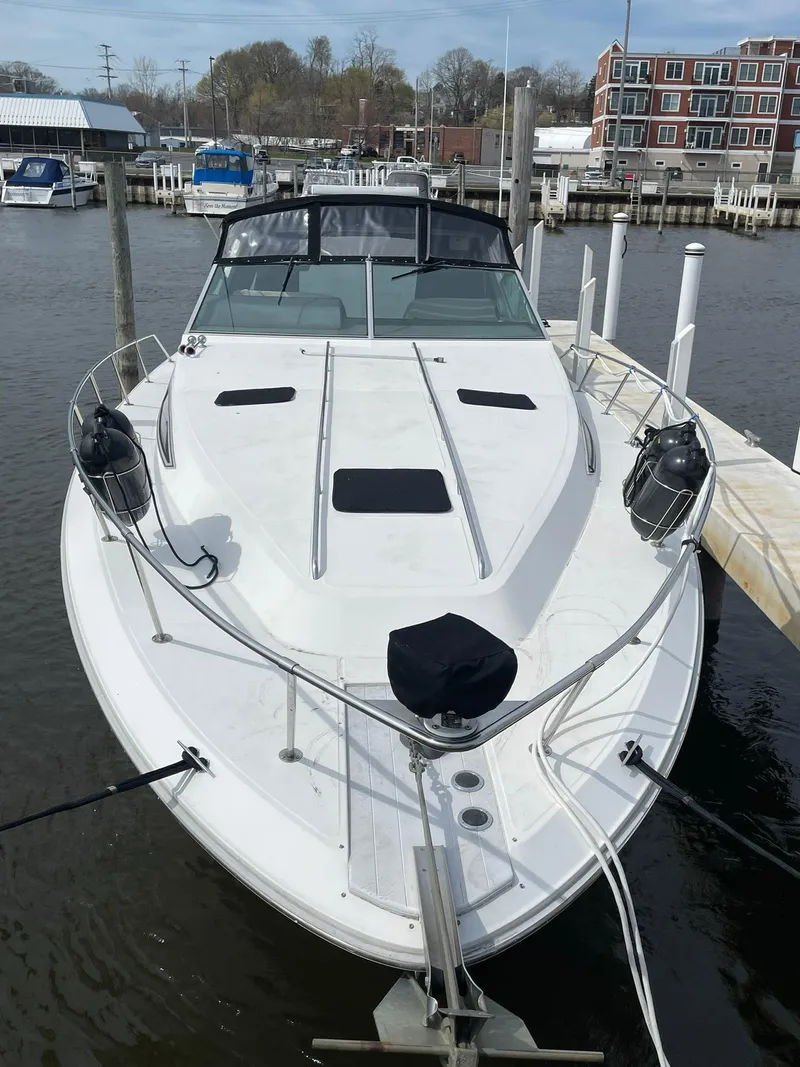 Slide: The Image of 1990 Sea Ray 390 Express Cruiser docked at marina, front view. - 3