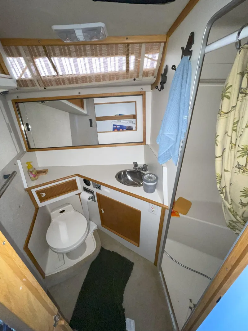 Slide: The Image of 1990 Sea Ray 390 Express Cruiser bathroom with shower, sink, and toilet. - 36