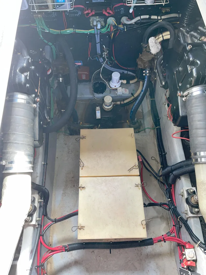 Slide: The Image of Engine compartment of a 1990 Sea Ray 390 Express Cruiser with visible wiring and components. - 37