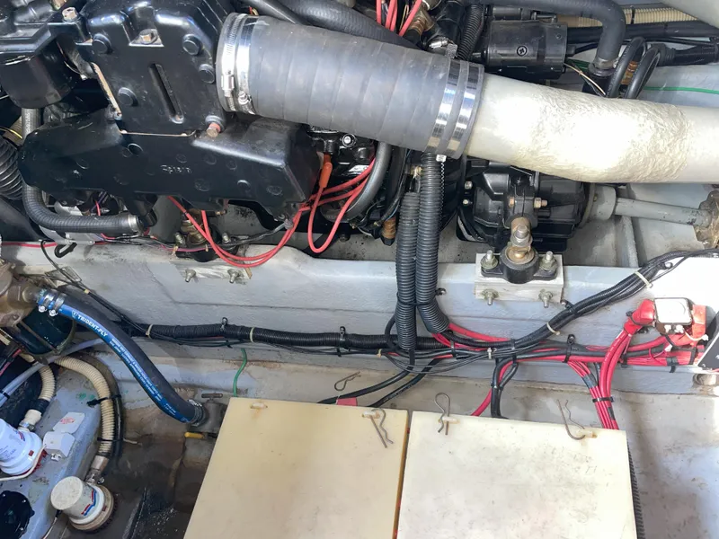 Slide: The Image of Engine compartment of a 1990 Sea Ray 390 Express Cruiser, showing hoses and wiring. - 38