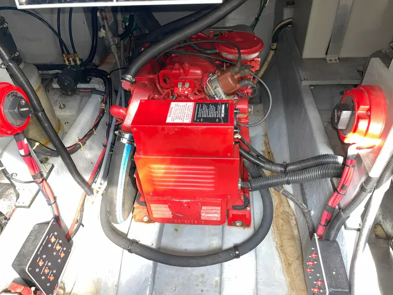 Slide: The Image of Engine compartment of a 1990 Sea Ray 390 Express Cruiser with red machinery and wiring. - 40