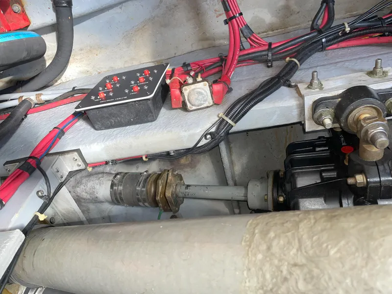 Slide: The Image of Engine compartment of a 1990 Sea Ray 390 Express Cruiser with wiring and mechanical components. - 41