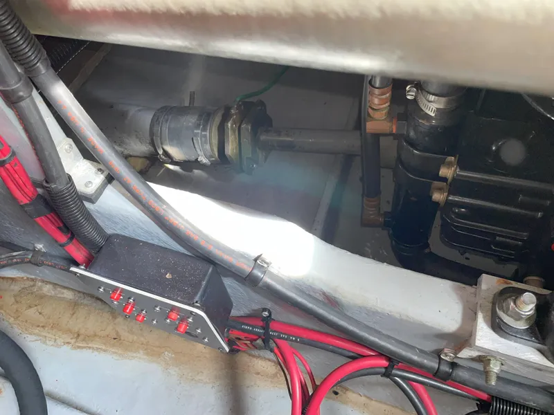 Slide: The Image of Engine compartment of a 1990 Sea Ray 390 Express Cruiser with visible wiring and components. - 42