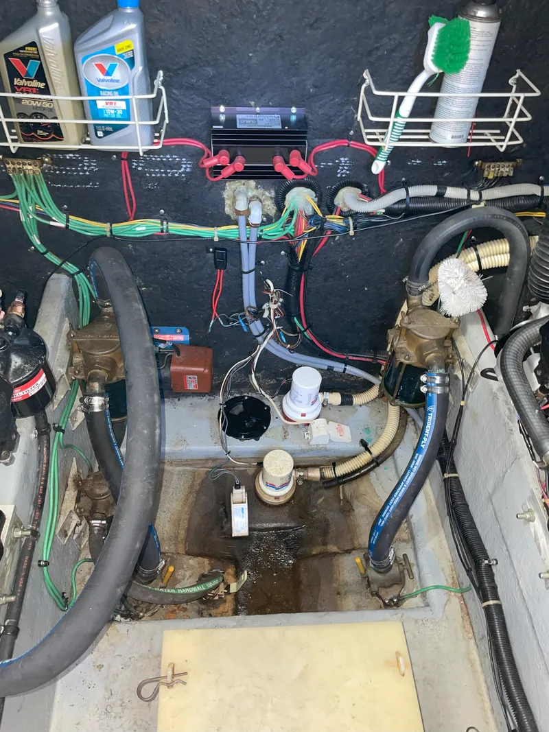 Slide: The Image of Engine room of a 1990 Sea Ray 390 Express Cruiser with visible wiring and components. - 43