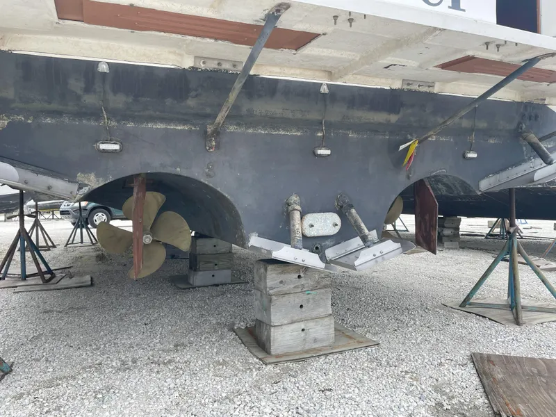 Slide: The Image of 1990 Sea Ray 390 Express Cruiser on stands, showing propellers and hull details. - 5