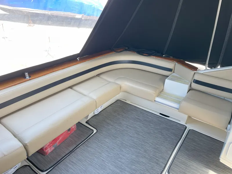Slide: The Image of 1990 Sea Ray 390 Express Cruiser interior with beige seating and carpeted floor. - 9