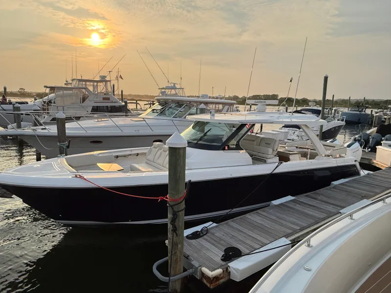 Slide: The Image of 2023 Tiara Yachts 43 LS docked at sunset, showcasing sleek design and luxury features. - 15