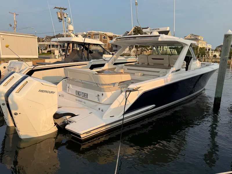 Slide: The Image of 2023 Tiara Yachts 43 LS docked, featuring sleek design and powerful Mercury engines. - 18