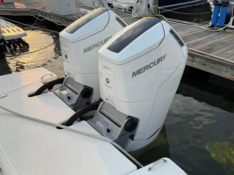 Slide: The Image of Twin Mercury outboard engines on a 2023 Tiara Yachts 43 LS at a marina. - 21