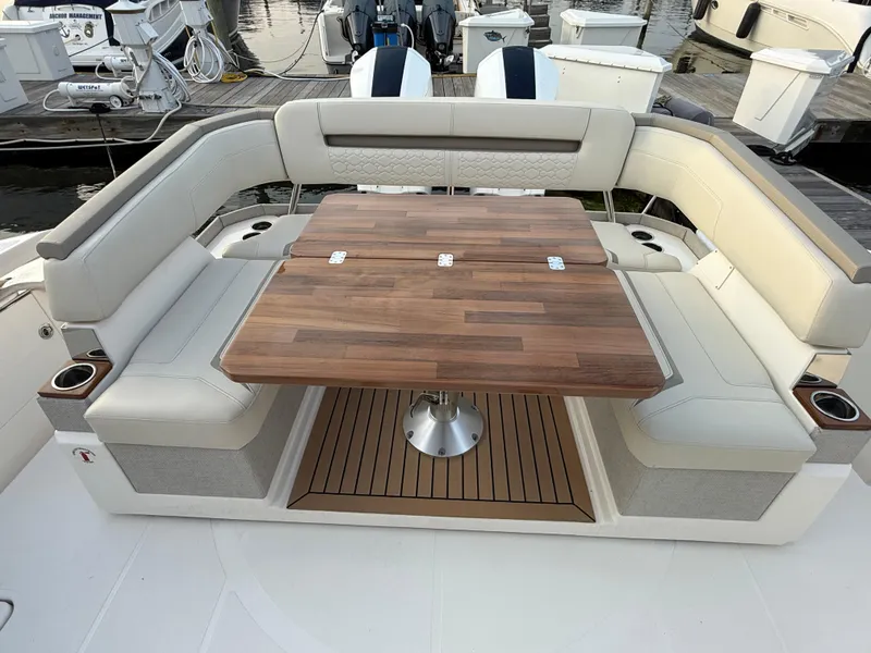 Slide: The Image of 2023 Tiara Yachts 43 LS boat with elegant seating and wooden table. - 23