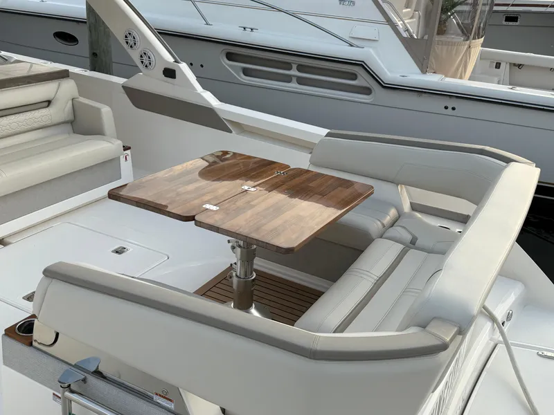 Slide: The Image of 2023 Tiara Yachts 43 LS interior with elegant seating and wooden table. - 24