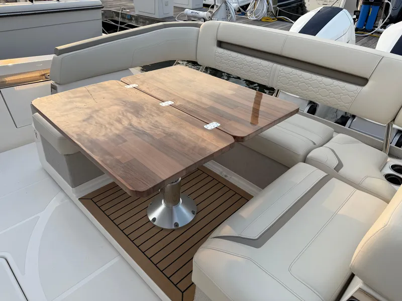 Slide: The Image of Luxurious seating area on 2023 Tiara Yachts 43 LS with elegant wooden table. - 25
