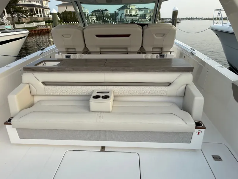 Slide: The Image of 2023 Tiara Yachts 43 LS luxury boat interior with plush seating and cup holders. - 26