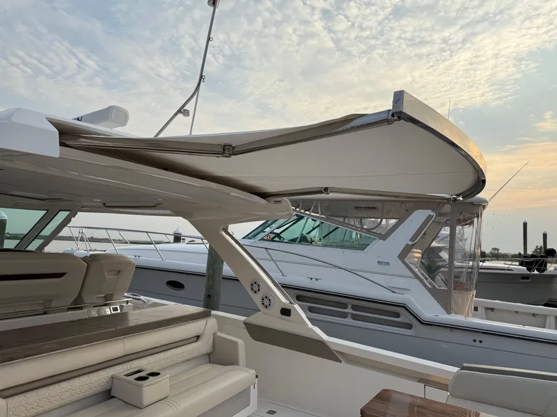 Slide: The Image of 2023 Tiara Yachts 43 LS with sleek design and luxurious seating at sunset. - 42