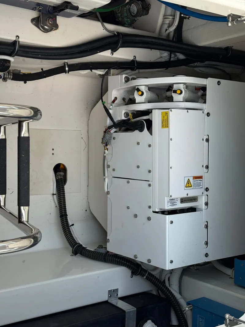 Slide: The Image of Engine compartment of 2023 Tiara Yachts 43 LS, showcasing mechanical components and wiring. - 56