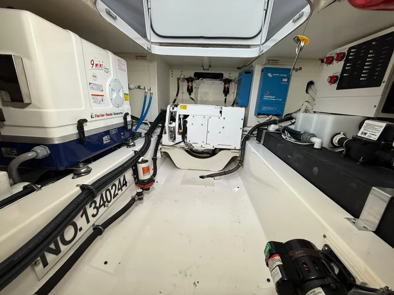 Slide: The Image of Engine room of 2023 Tiara Yachts 43 LS, featuring equipment and wiring. - 58