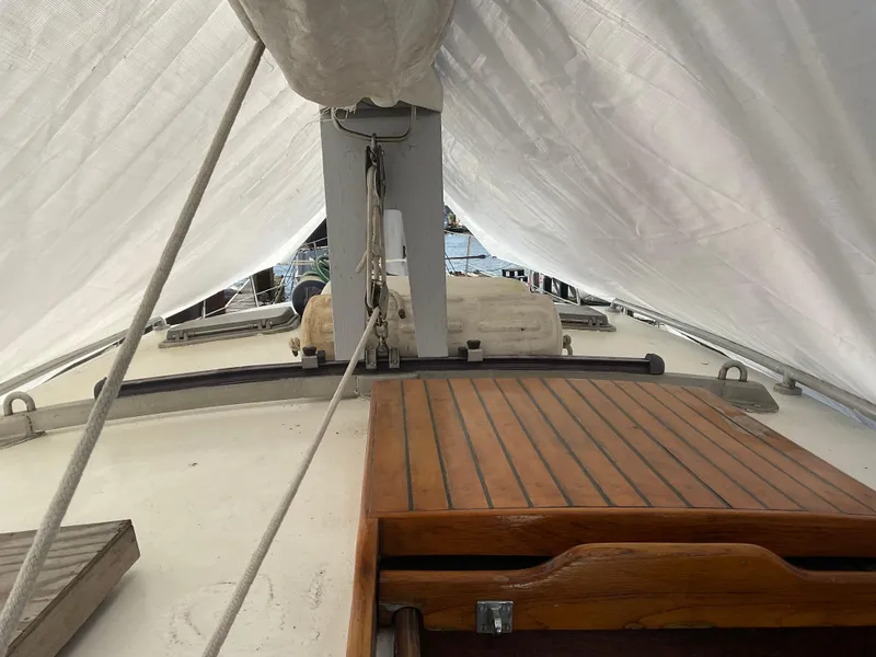 Slide: The Image of 1980 Kanter Staysail Cutter deck with wooden hatch and rigging under sail. - 10