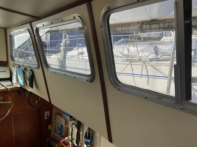 Slide: The Image of Interior view of 1980 Kanter Staysail Cutter, showcasing windows and nautical equipment. - 17