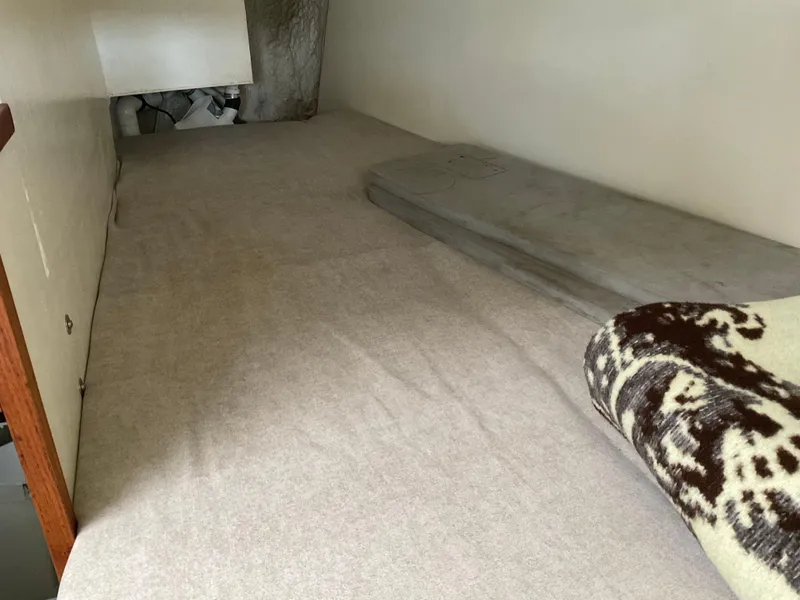 Slide: The Image of 1980 Kanter Staysail Cutter interior cabin with bed and blanket. - 21