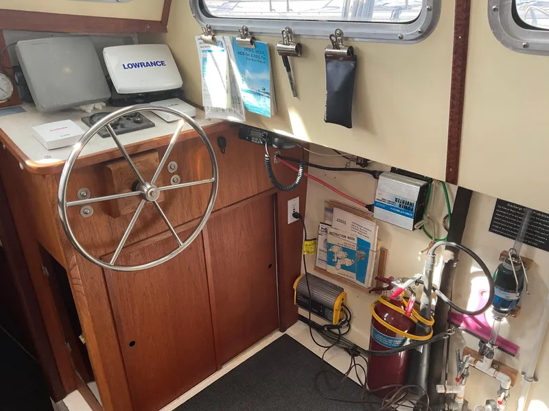 Slide: The Image of 1980 Kanter Staysail Cutter helm with navigation equipment and steering wheel. - 25