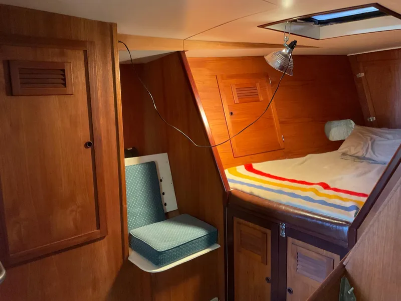 Slide: The Image of Cozy cabin interior of 1980 Kanter Staysail Cutter with wooden finish and bed. - 28