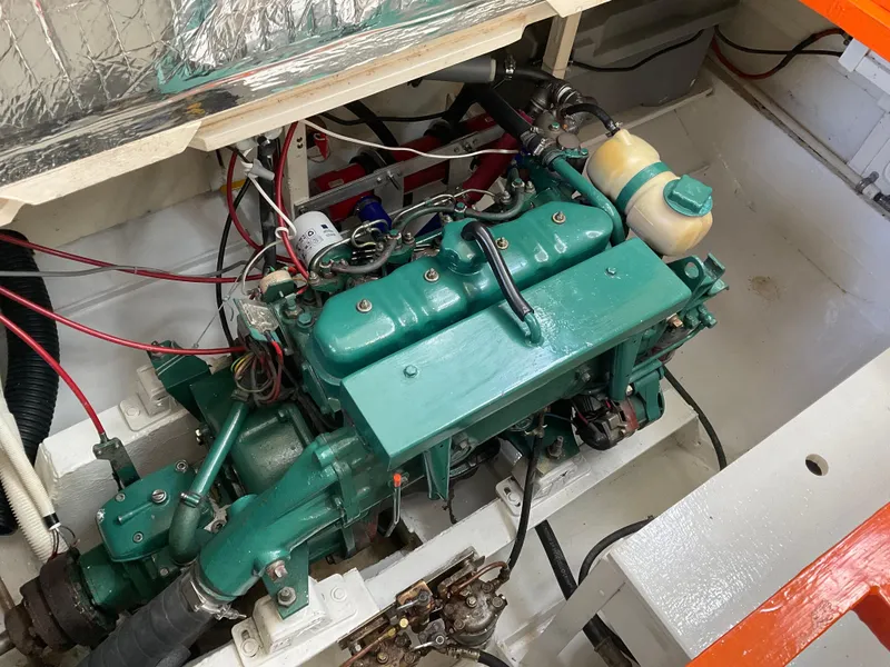 Slide: The Image of Engine compartment of a 1980 Kanter Staysail Cutter, showcasing a well-maintained marine engine. - 34