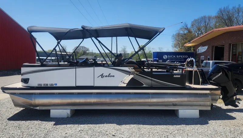 Slide: The Image of 2024 Avalon LSZ 2385 Rear Lounger pontoon boat with canopy, displayed outdoors. - 3
