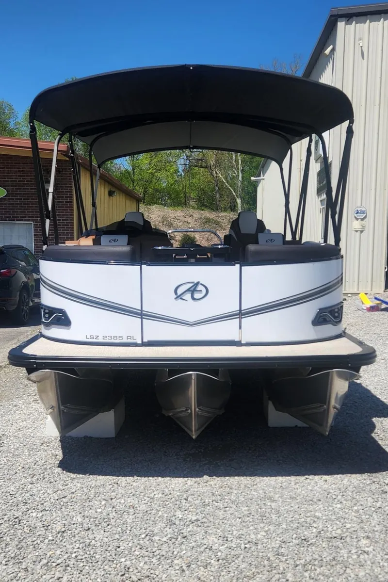 Slide: The Image of 2024 Avalon LSZ 2385 Rear Lounger pontoon boat, parked outdoors, rear view. - 4