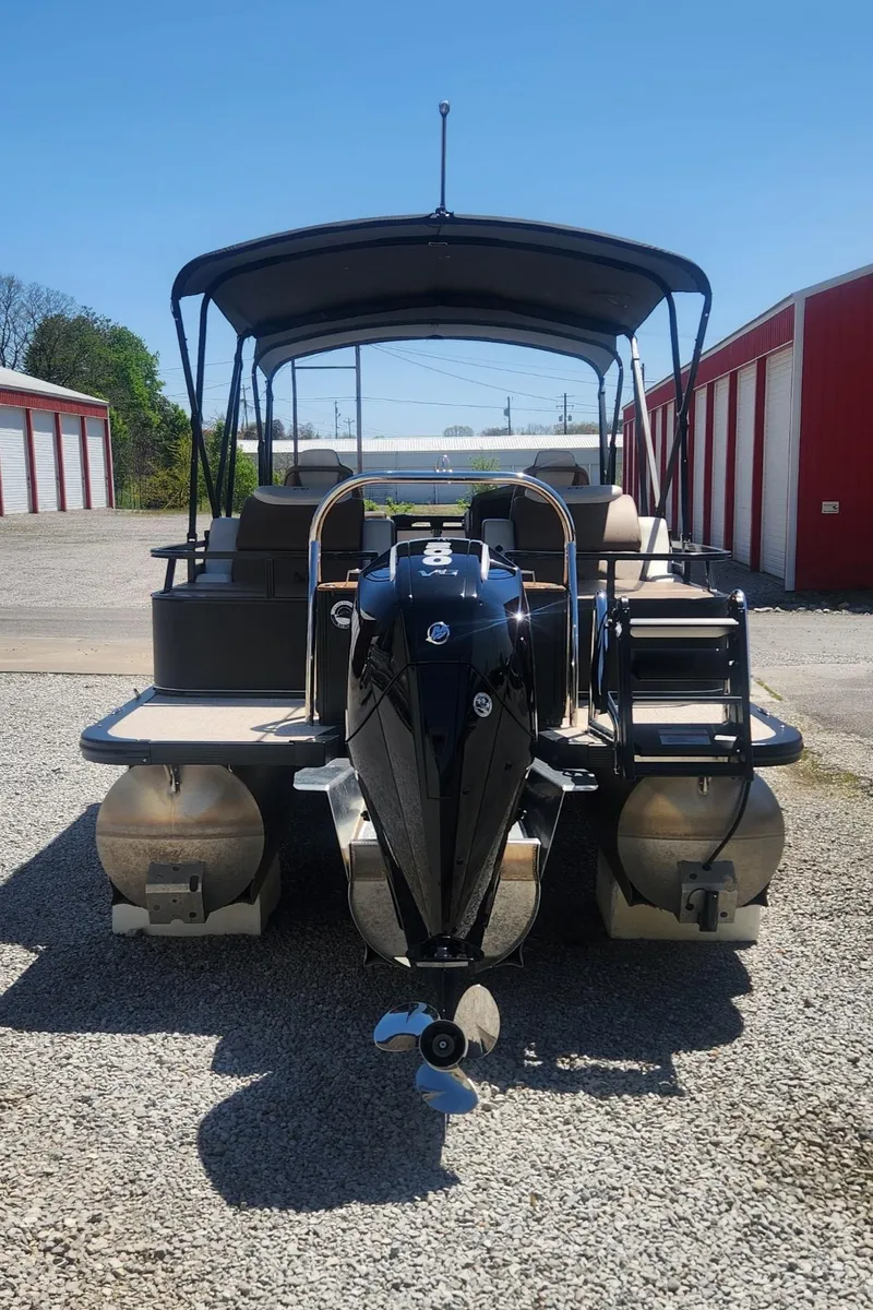 Slide: The Image of 2024 Avalon LSZ 2385 Rear Lounger pontoon boat with canopy, parked outdoors. - 5