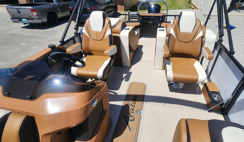 Slide: The Image of 2024 Avalon LSZ 2385 Rear Lounger boat interior with tan and white seating. - 8