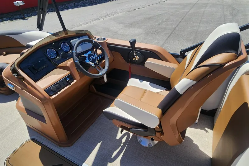 Slide: The Image of 2024 Avalon LSZ 2385 Rear Lounger boat interior with luxurious seating and modern dashboard. - 9