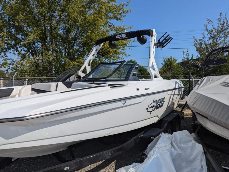 Slide: The Image of 2019 Axis A22 boat on trailer, white exterior, parked outdoors. - 1