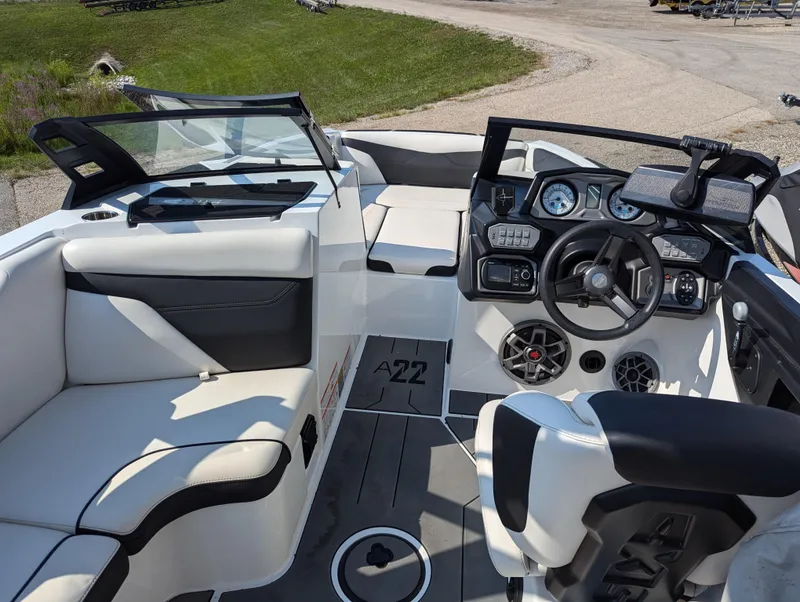 Slide: The Image of 2019 Axis A22 boat interior with modern dashboard and seating. - 10