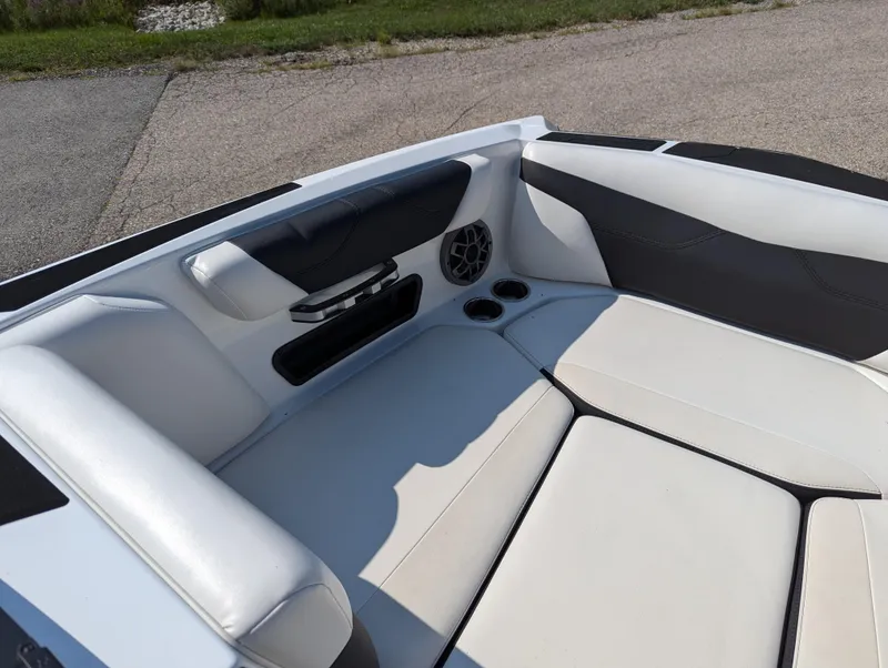 Slide: The Image of 2019 Axis A22 boat interior with white seating and speaker system. - 12