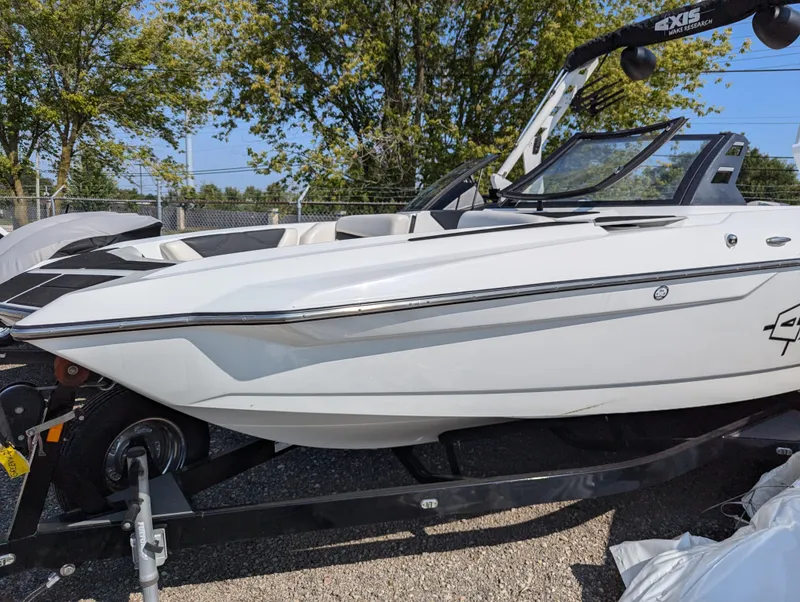 Slide: The Image of 2019 Axis A22 boat on trailer, white exterior, parked outdoors. - 3